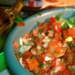 Homemade salsa guacamole and steamed artichoke